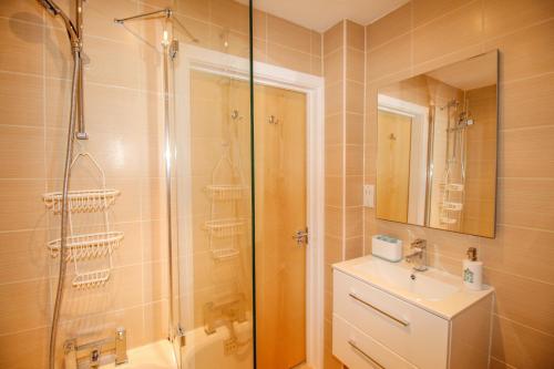a bathroom with a shower and a toilet and a sink at 7 Harbour Reach in Weymouth