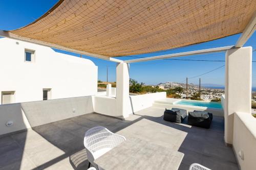a view of a patio with chairs and a swimming pool at SERAPIAS SUITES in Éxo Goniá