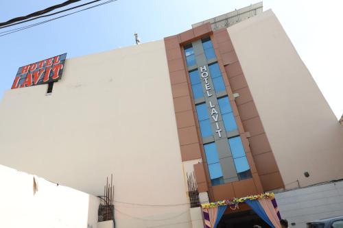 a building with a sign on the side of it at Hotel Lavit Couple Friendly near Faridabad Metro station in Faridabad