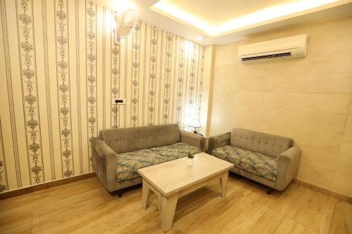 a living room with a couch and a table at Hotel Lavit Couple Friendly near Faridabad Metro station in Faridabad