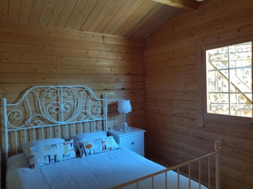 a bedroom with a bed and a window at Casa do Vale de Gondra in Castelo de Paiva