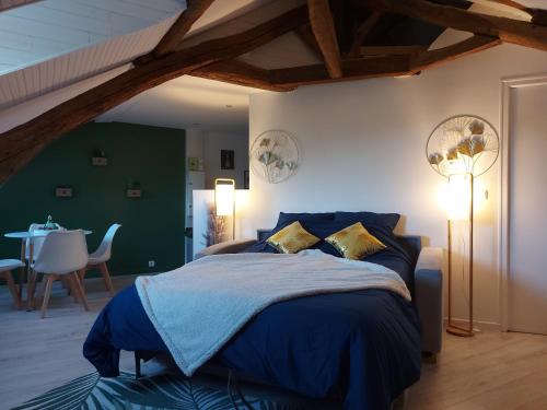 a bedroom with a blue bed and a table at Le Marché Cosy à Vernon-Giverny - Claude Monet - Downtown in Vernon