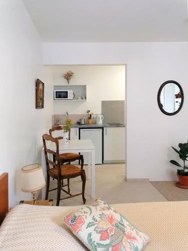 a bedroom with a bed and a table and a kitchen at DUNKE in Dunkerque