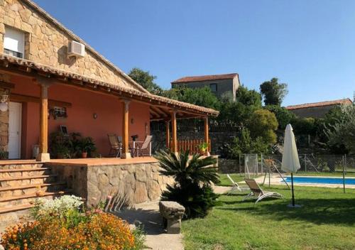 a house with a patio and a swimming pool at CASA SEBASTIANA SUITE in Losar de la Vera