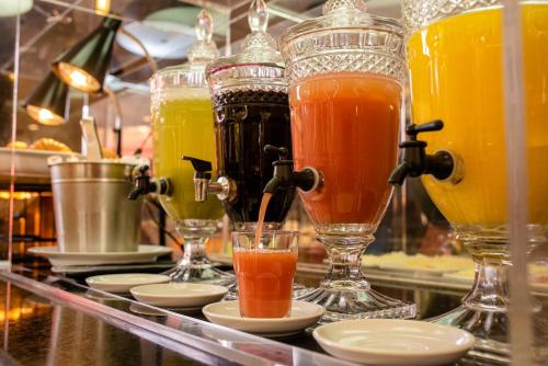 a row of different types of drinks on a counter at ibis Betim in Betim