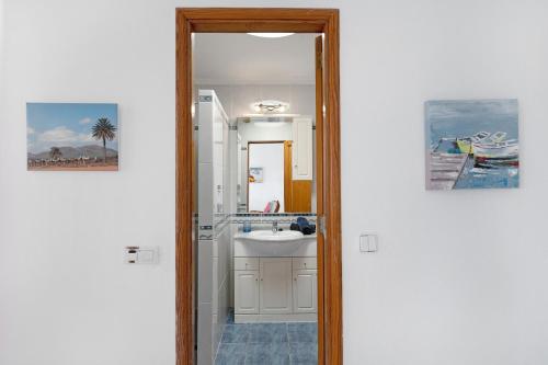 a bathroom with a sink and a mirror at Puerto Chico 9 in Playa Blanca