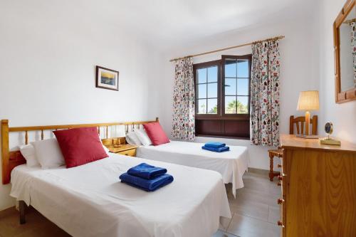 a hotel room with two beds and a window at Puerto Chico 9 in Playa Blanca