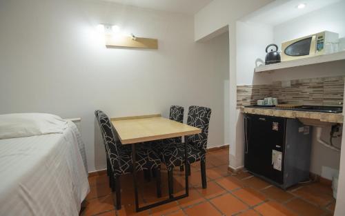 a small kitchen with a table and chairs in a room at Hacienda Don Justo Hotel Boutique Spa in Colón