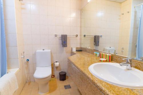 a bathroom with a toilet and a sink at Fully equipped studio near to metro - HRI in Dubai