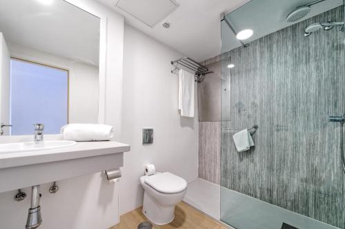 a bathroom with a sink and a toilet and a shower at Morasol Suites in Puerto Rico de Gran Canaria