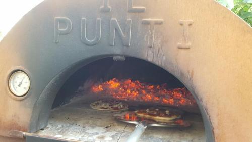 a pizza oven with pizzas cooking in it at Podere Lama in Castelnuovo di Val di Cecina