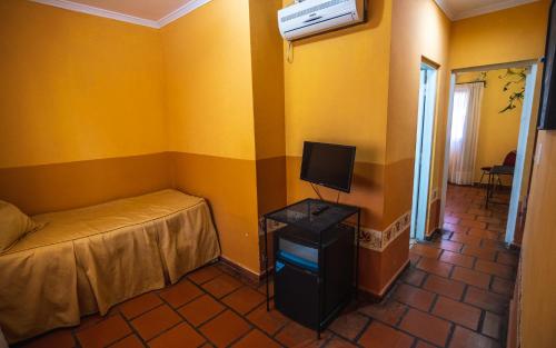a bedroom with a bed and a tv in a room at Hacienda Don Justo Hotel Boutique Spa in Colón
