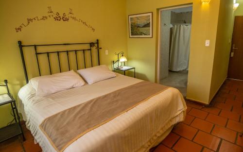 a bedroom with a large bed in a room at Hacienda Don Justo Hotel Boutique Spa in Colón