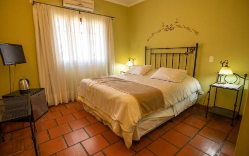 a bedroom with a large bed and a television at Hacienda Don Justo Hotel Boutique Spa in Colón
