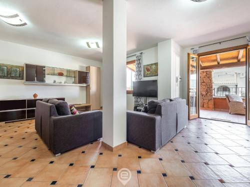 a living room with two chairs and a table at House Federica in Villasimius