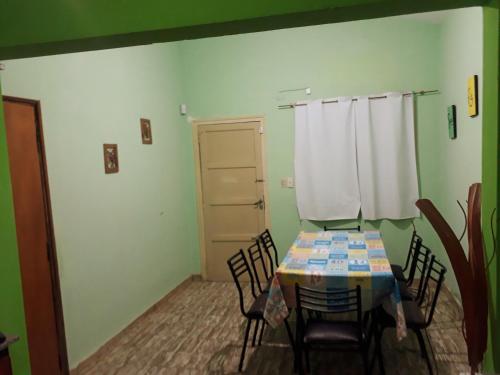 a dining room with a table and chairs and a door at Urquiza61 in Capilla del Monte