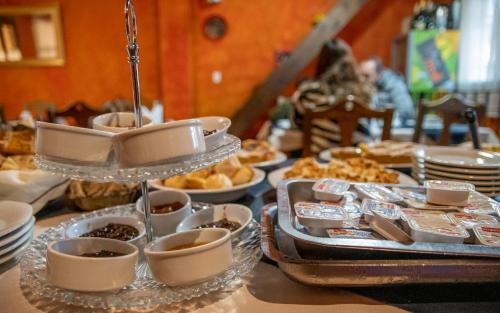 a table with a tray of desserts and pastries at Hacienda Don Justo Hotel Boutique Spa in Colón