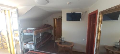 a room with two bunk beds and a table at Geltona in Šiauliai