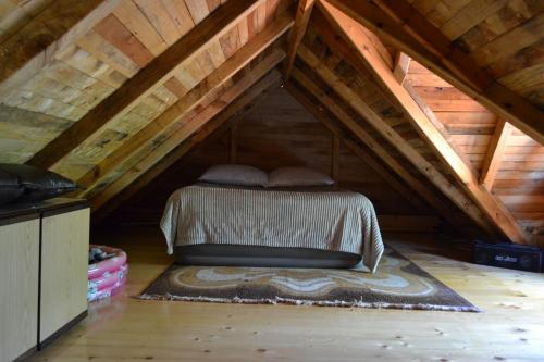 a bed in the middle of a attic at Drinski dragulj in Višegrad