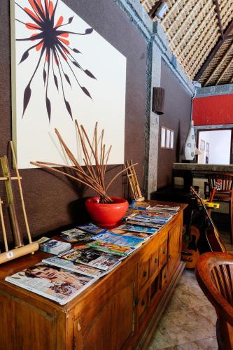 a wooden cabinet with a table with a plant on it at Ellies Hotel in Nusa Dua