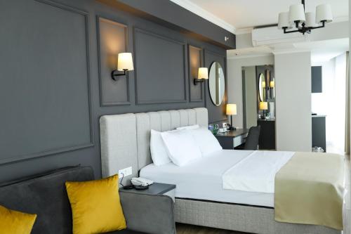 a bedroom with a large white bed with yellow pillows at FONTANA VERDE in Istanbul