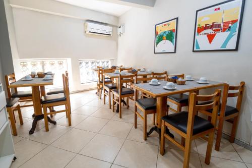 a dining room with wooden tables and chairs at Hotel Vital, Rio de Janeiro in Rio de Janeiro