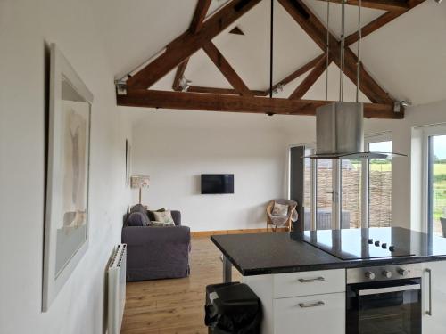 a kitchen with a black counter top in a room at The Stables and Granary at Shawbroom Farm in Cheswardine
