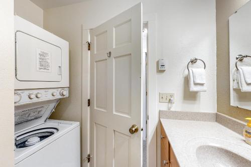 a white laundry room with a washer and dryer at Ponderosa 2A Permit #3,01630 in Crested Butte