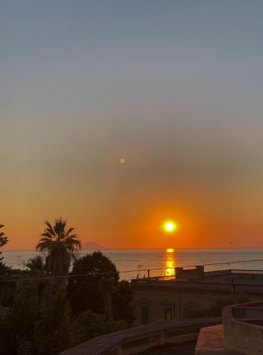 a sunset over the ocean with the sun in the sky at NoOne Tropea Guesthouse in Tropea