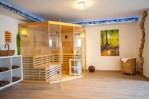 a glass display case in a room with wooden floors at Das Arni´s in Mehlmeisel