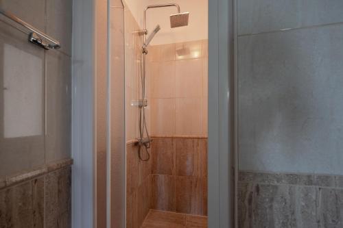 baño con ducha y puerta de cristal en Felix Villa with magic view and heated pool, en Ayía Paraskeví