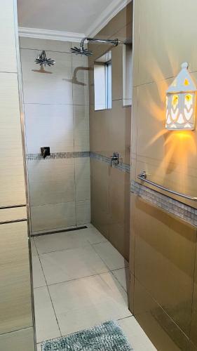a bathroom with a shower with a glass door at Stay at 11 on Gull in Cape Town