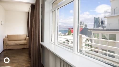a room with a window with a chair and a view at Center Hotels Klopp in Reykjavík