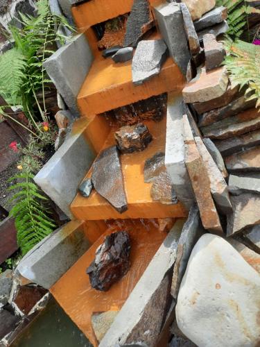 a pile of rocks on top of a pile of wood at Pensiunea Magura Ocnei in Tîrgu Ocna