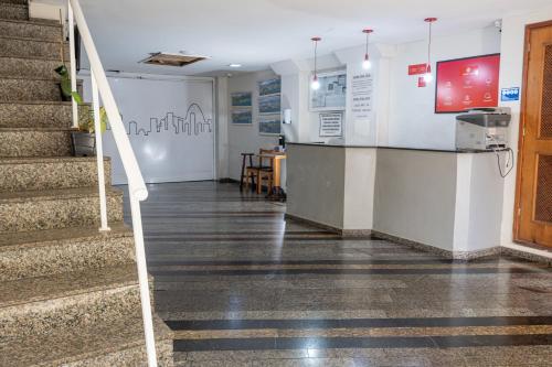 a lobby with stairs and a counter in a building at Hotel Vital, Rio de Janeiro in Rio de Janeiro
