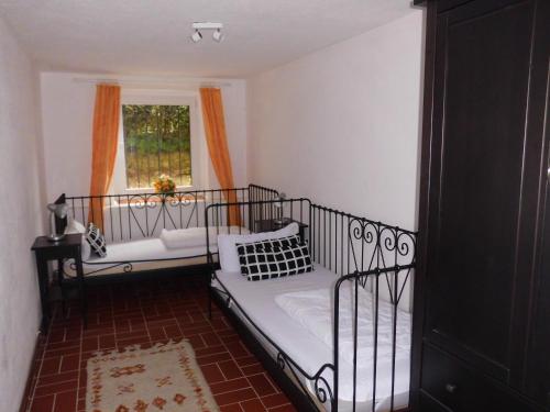 a bedroom with a bed and a window at Gutshaus Wohlenhagen in Wohlenberg