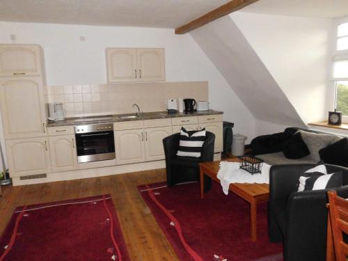 a living room with a couch and a table at Gutshaus Wohlenhagen in Wohlenberg