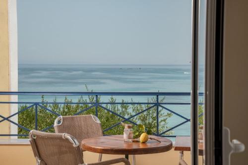 a table and chairs with a view of the ocean at Bella Vista Sea View Apartments in Tragaki