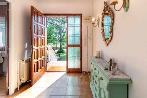 a kitchen with a green cabinet and a door at Can Pons De Dalt Casa rural a la Selva in Girona