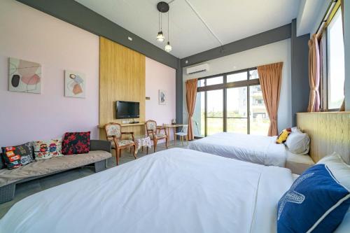a hotel room with two beds and a table at Horse Riding Next Door in Yuanshan