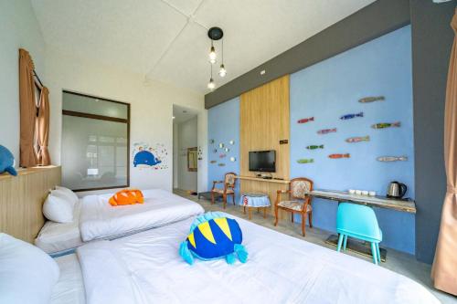 a hotel room with two beds and a desk at Horse Riding Next Door in Yuanshan