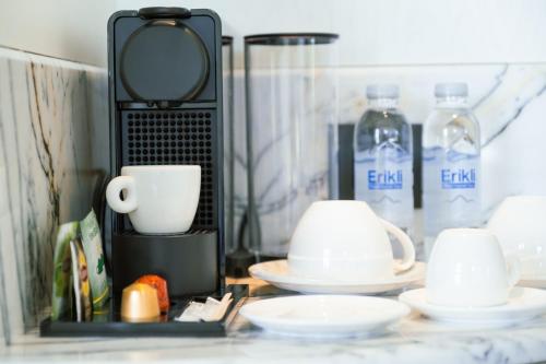 a shelf with cups and plates and water bottles at The Gift Hotel in Istanbul
