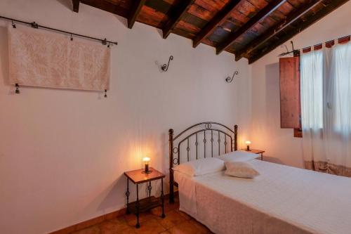 a bedroom with a bed and two candles on tables at Il Monastero in Geremèas
