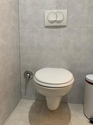 a bathroom with a white toilet in a room at Latin Bridge Apartment Sarajevo in Sarajevo