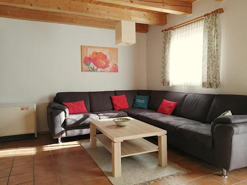 uma sala de estar com um sofá preto e uma mesa em Ferienhaus Meineke em Regen