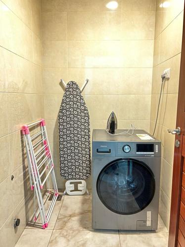 a washer and dryer in a corner of a room at Fairview Luxury Apartments in Dar es Salaam