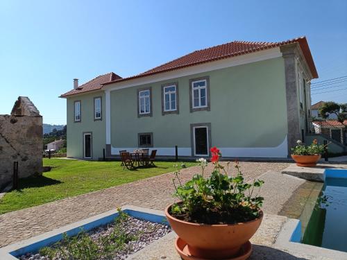 a large white house with a pool in front of it at Casa Brandao in Vale de Cambra