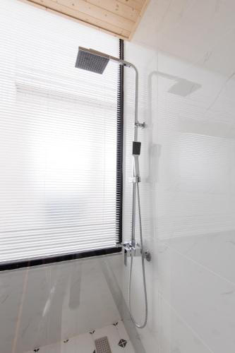 a shower in a bathroom with a window at Good Times BnB in Chishang
