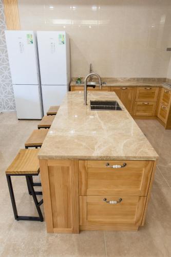 a kitchen with a sink and a refrigerator at Good Times BnB in Chishang