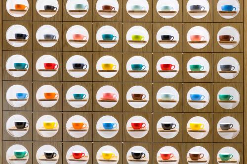 a wall of white plates on a brick wall at Good Times BnB in Chishang